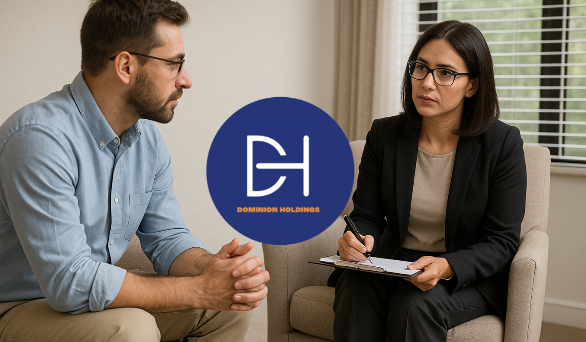 A female psychologist attentively listening and taking notes during a private session with a male client in a calm, well-lit office.