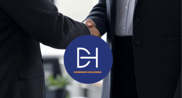 Two professionals in business attire shaking hands in an office setting with a window and plants, symbolizing a successful agreement or hire supported by psychometric assessments.